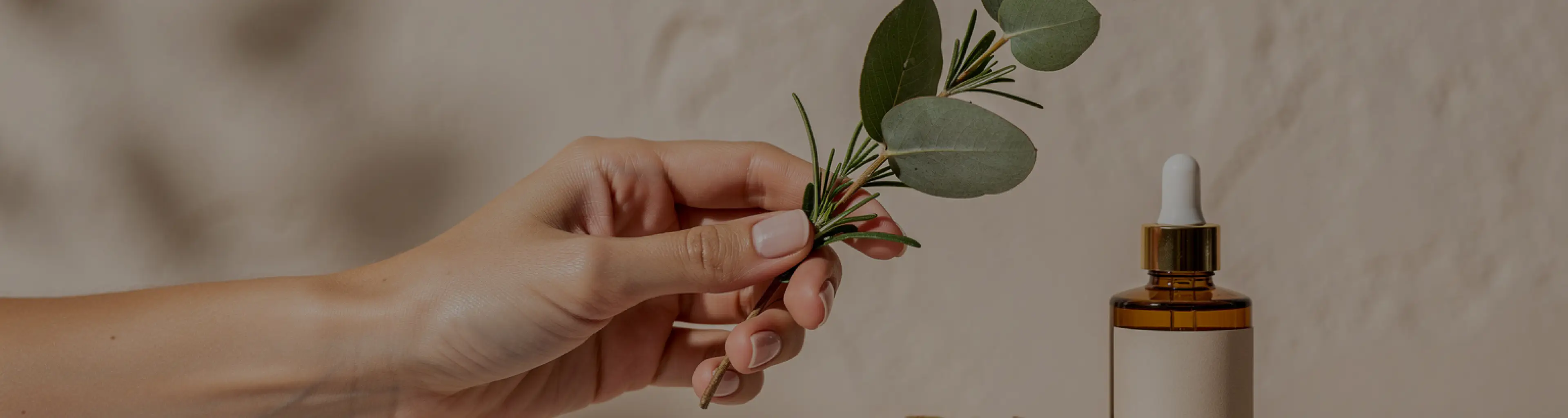 A botanical skincare ritual with leaves and an amber bottle